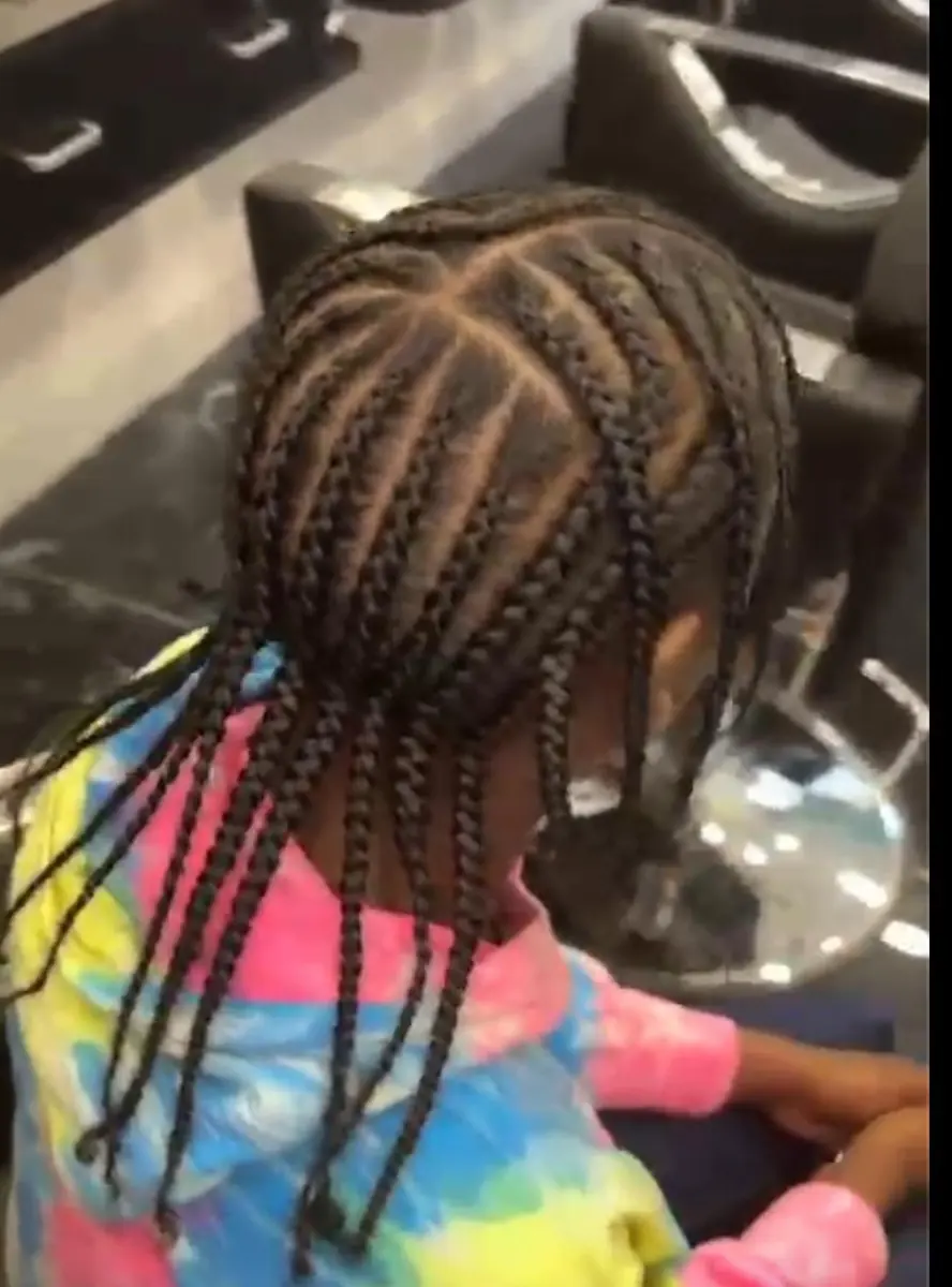 Child’s braids in colourful styling
